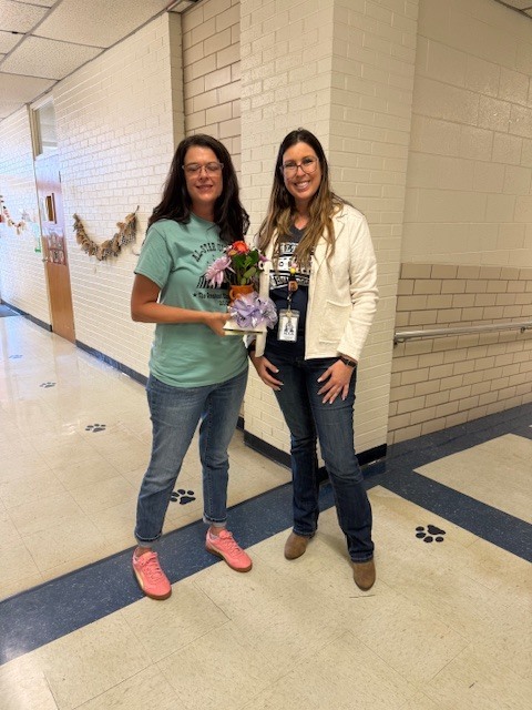 Mrs. Cook with her flowers and gift.