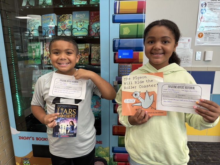 Students holding books.