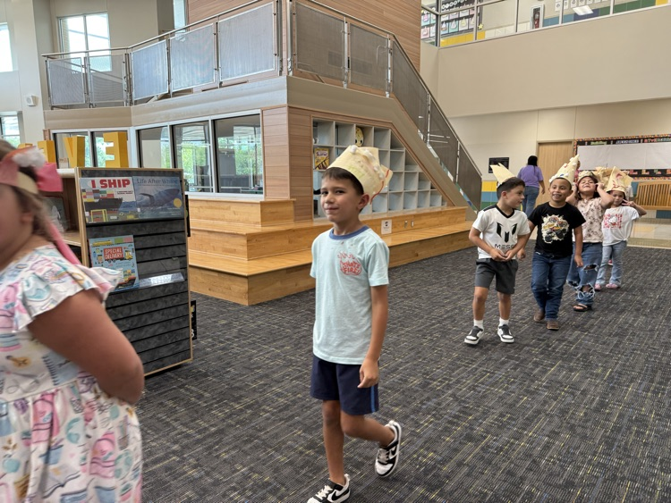 Students wearing handmade hats.