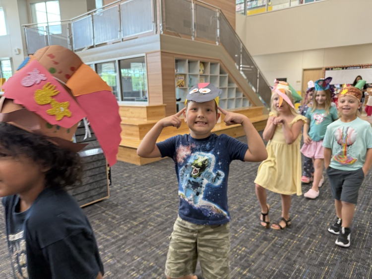 Students wearing handmade hats.