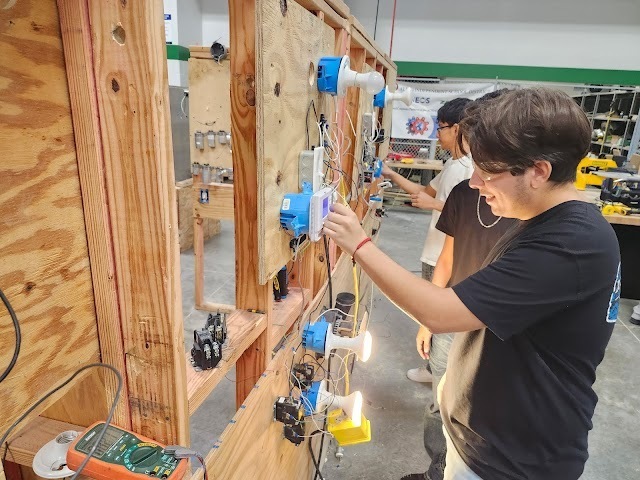Student working on wiring/electrical skills in HVAC class