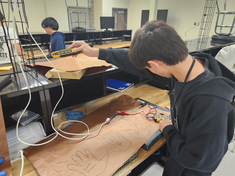 computer maintenance student working on cables