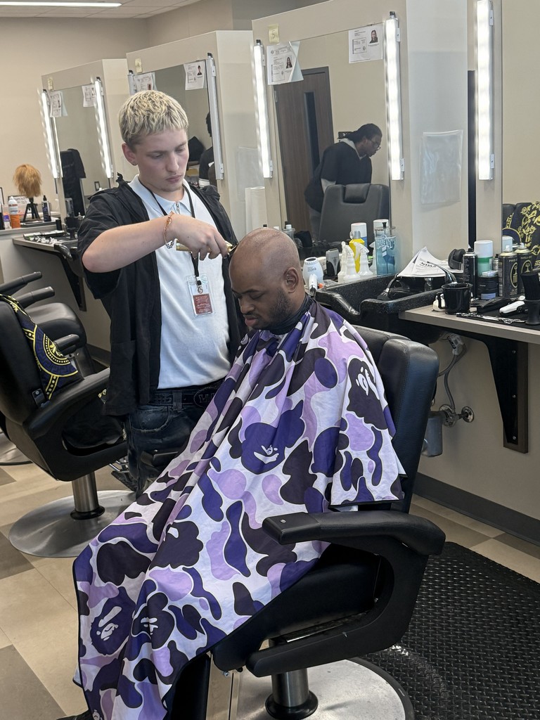 Barber student cutting hair