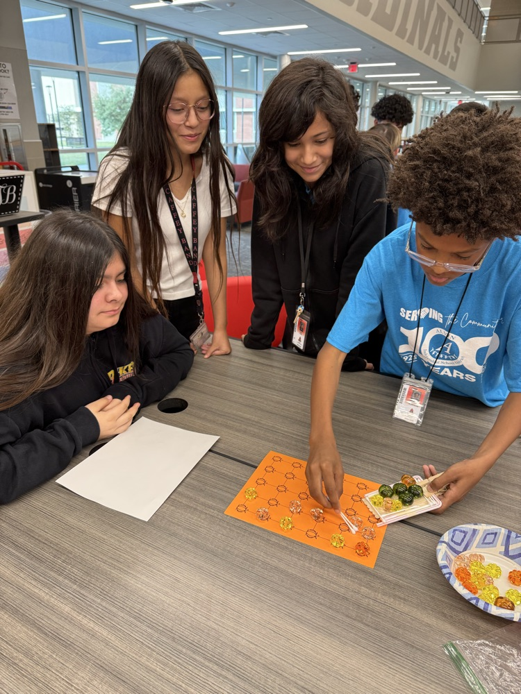 Students working to “harvest pumpkins” with limited resources