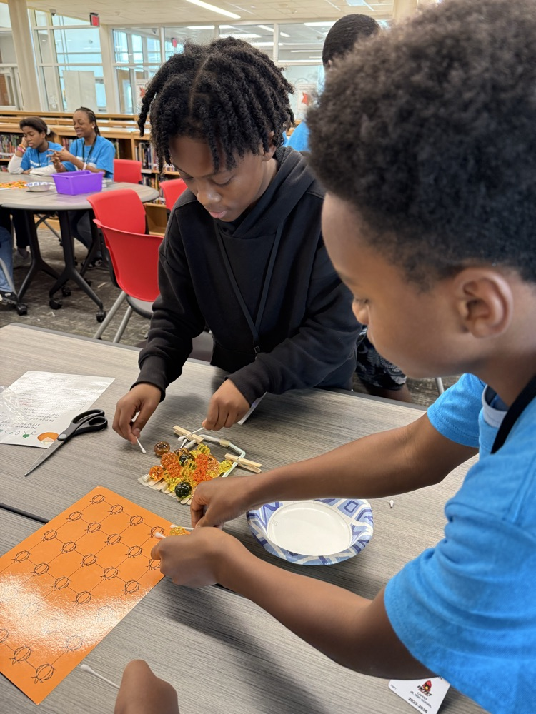 Students working to “harvest pumpkins” with limited resources