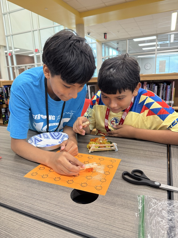 Students working to “harvest pumpkins” with limited resources