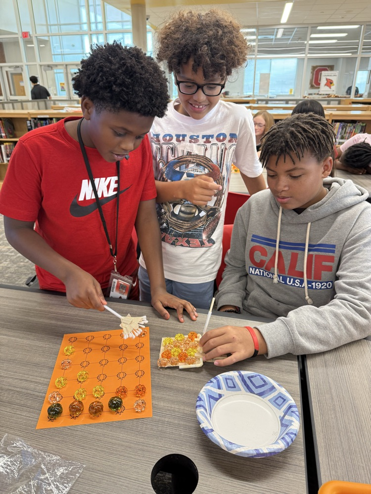 Students working to “harvest pumpkins” with limited resources