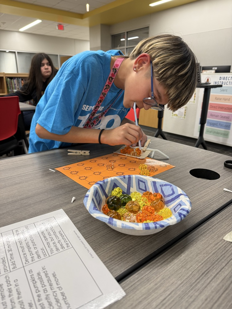 Students working to “harvest pumpkins” with limited resources