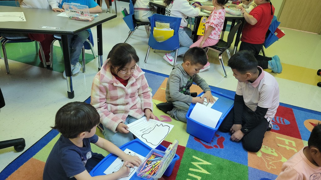 Students working on writing together.