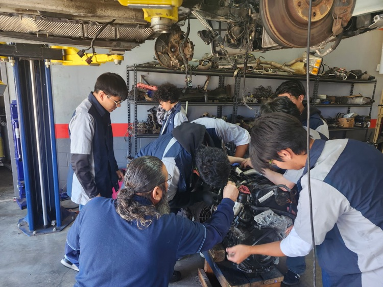 auto two working on a Volkswagen motor