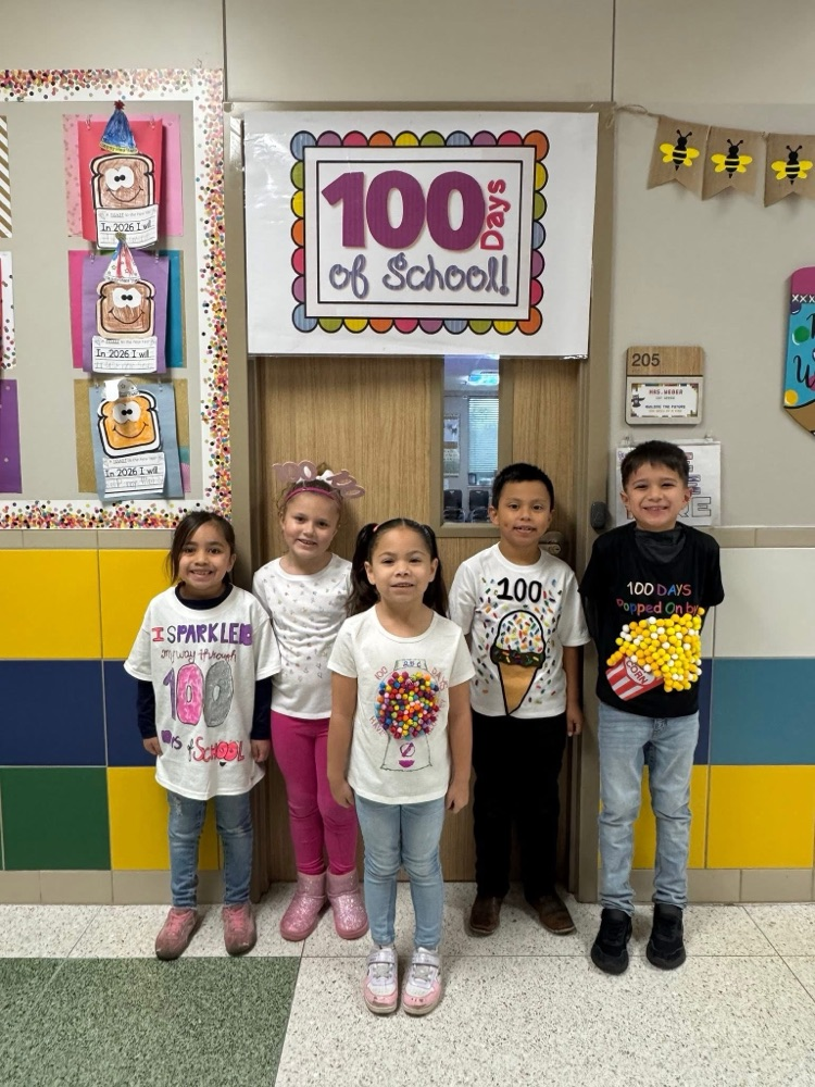Students standing in front of a 100 days of school banner.