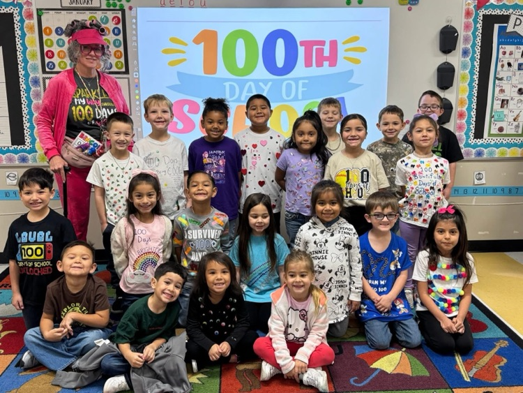Students and teacher celebrating 100 days of school.