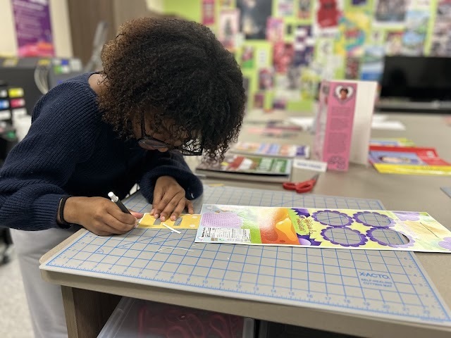 Graphic Design II students working on drink packaging project