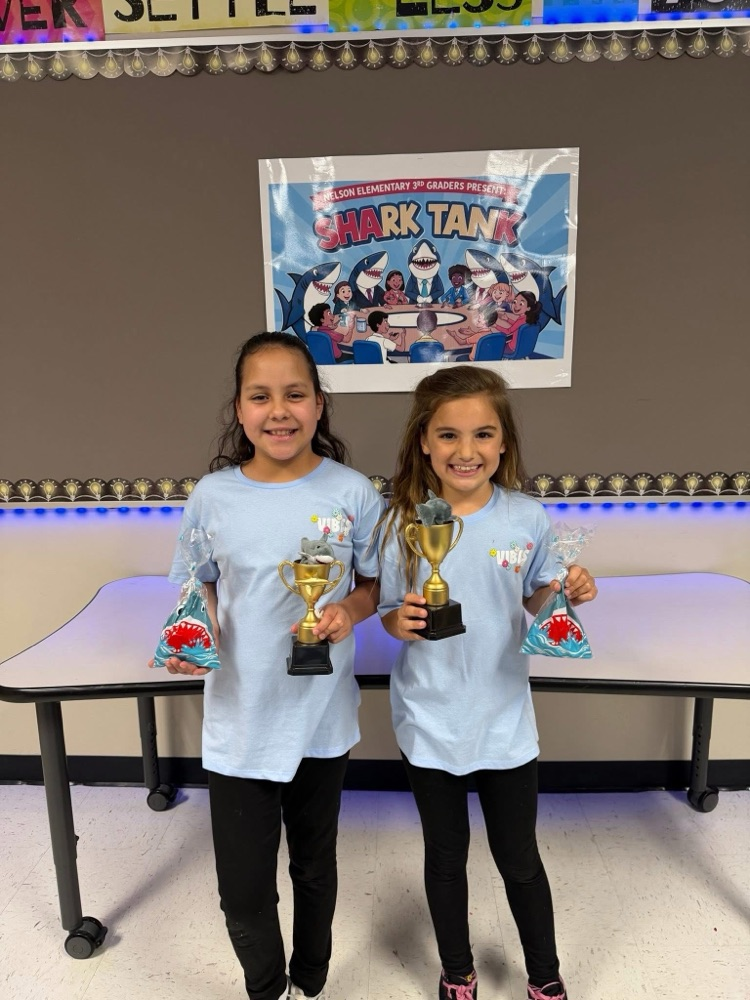 Students who participated in the Shark Tank with trophies