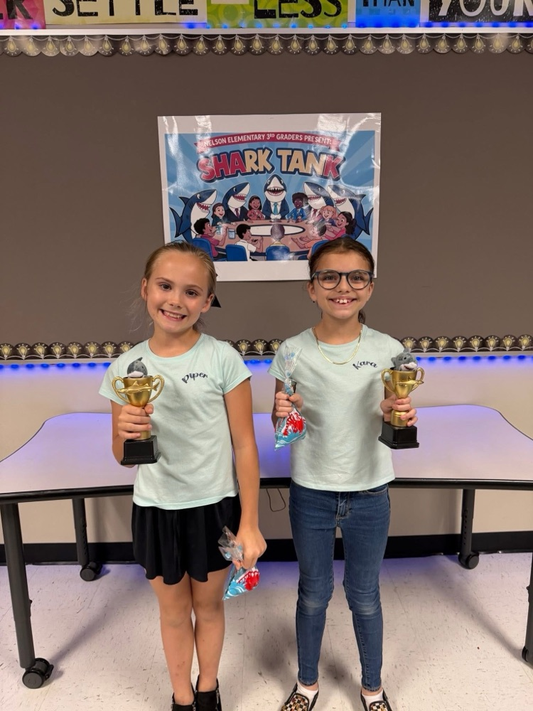 Students who participated in Shark Tank with trophies