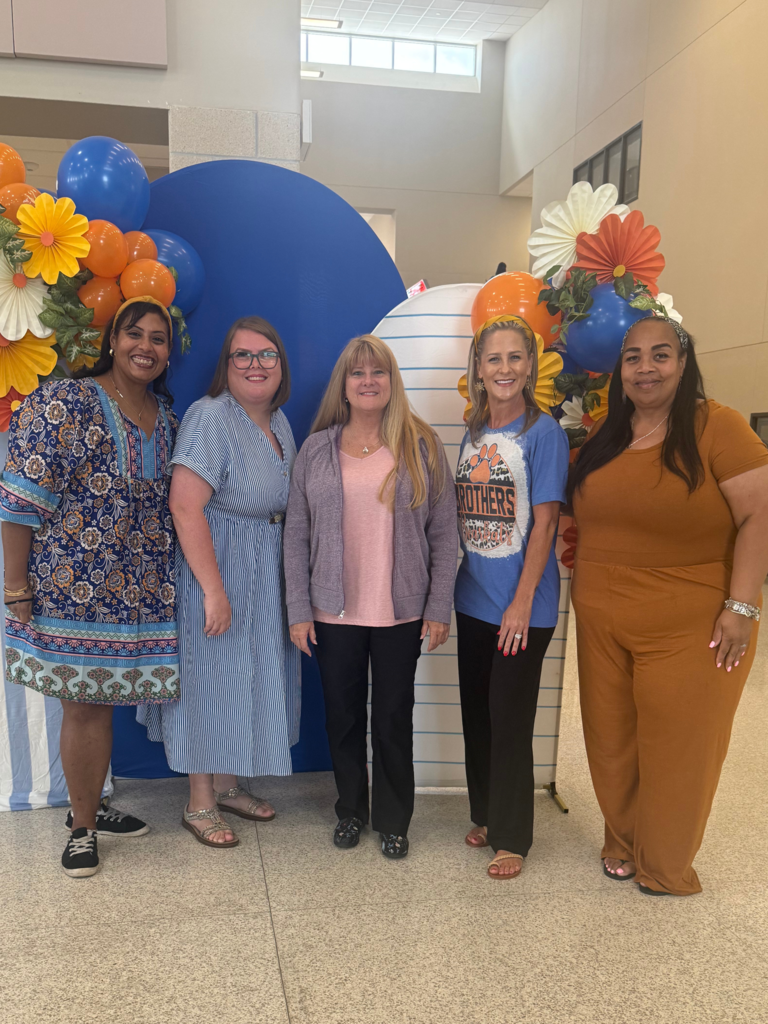 Teachers posing with smiles during back to school activities