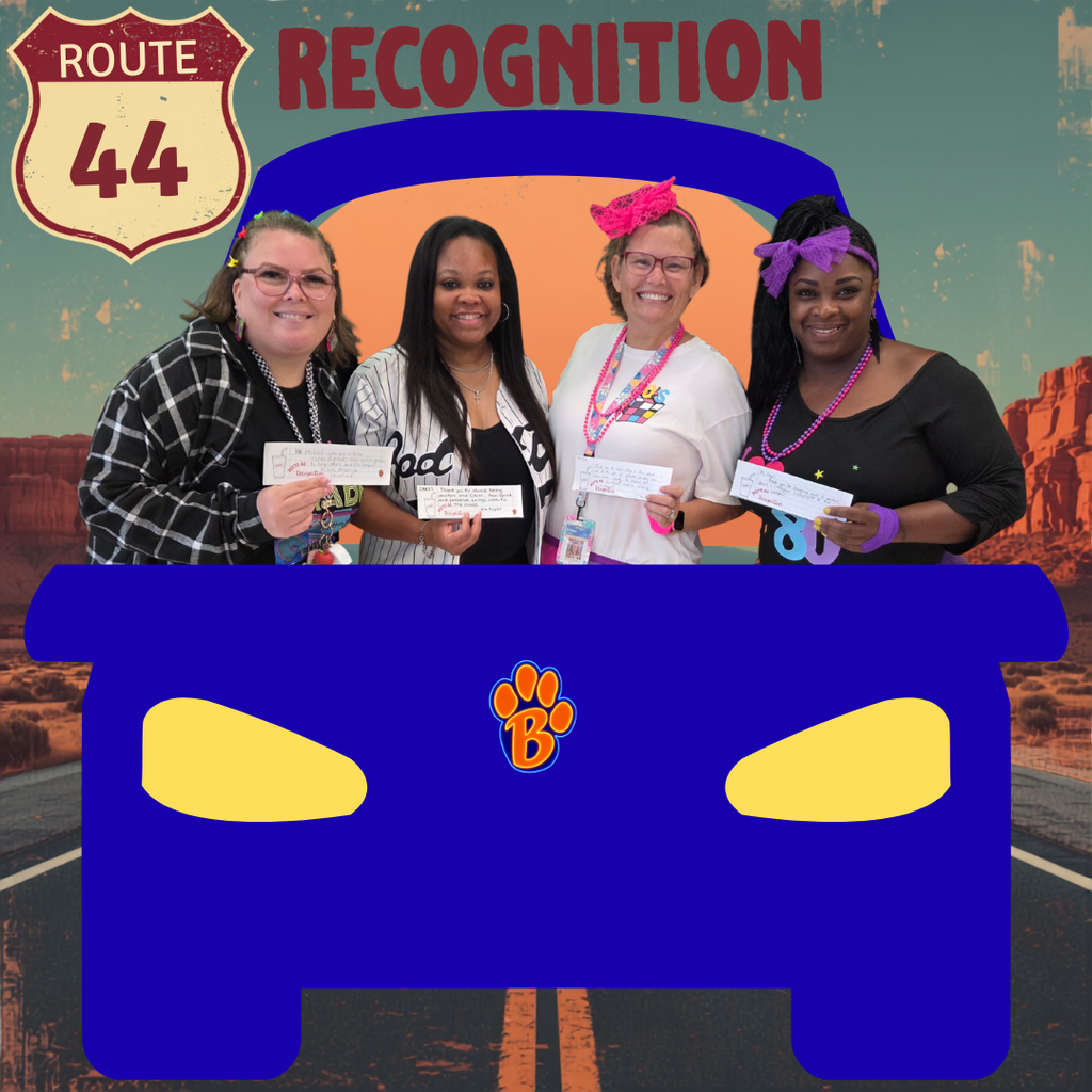 Route 44 Recognition.  Four teachers in a blue car posing with their written note explaining why they were selected for the recognition. 