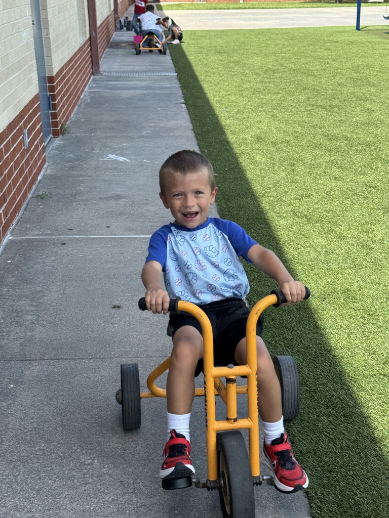 child riding tricycle