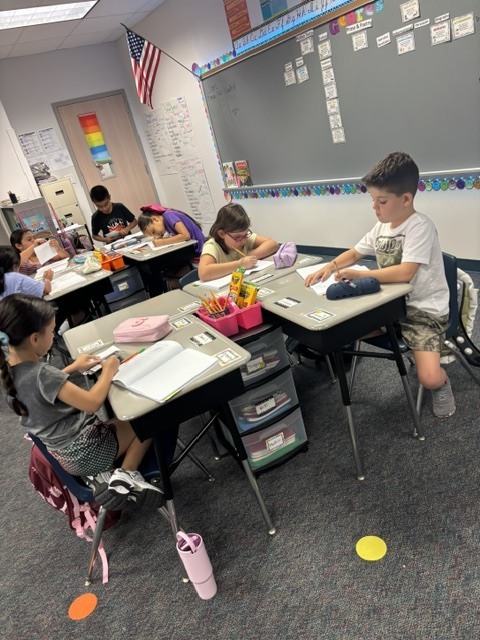 students writing at desk
