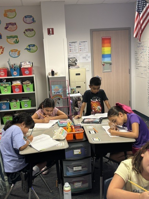 students writing at desk