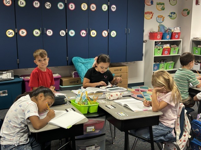 students writing at desk