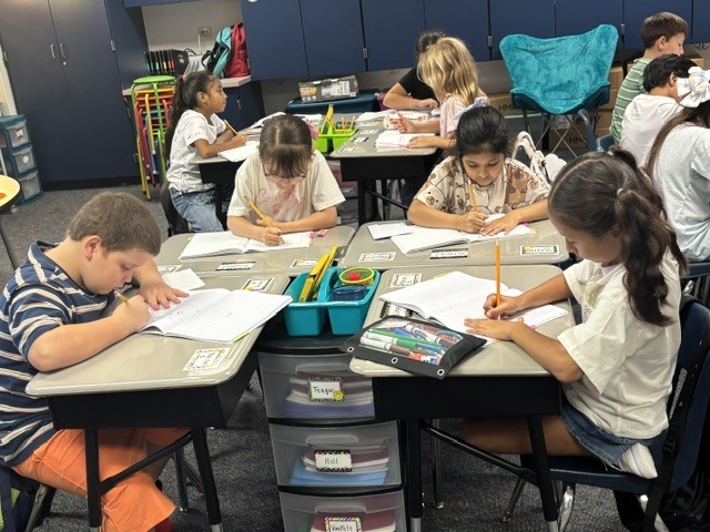 students writing at desk