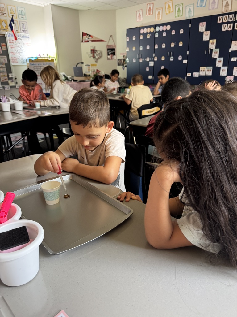 students putting water on penny