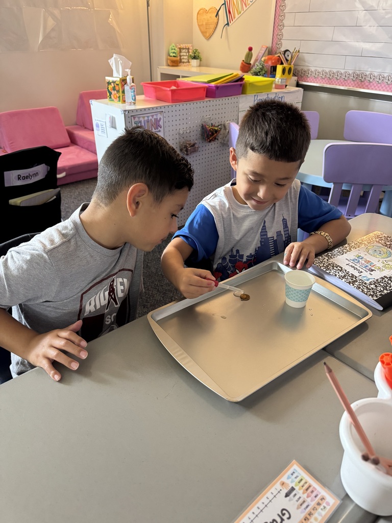 students putting water on penny