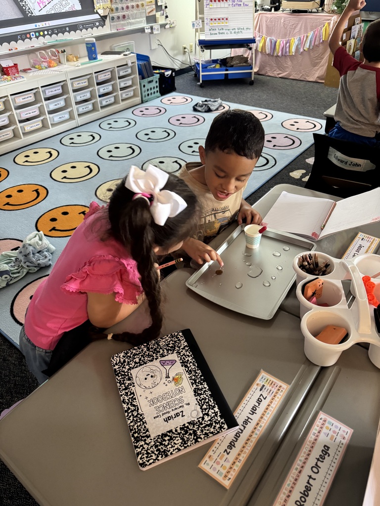 students putting water on penny