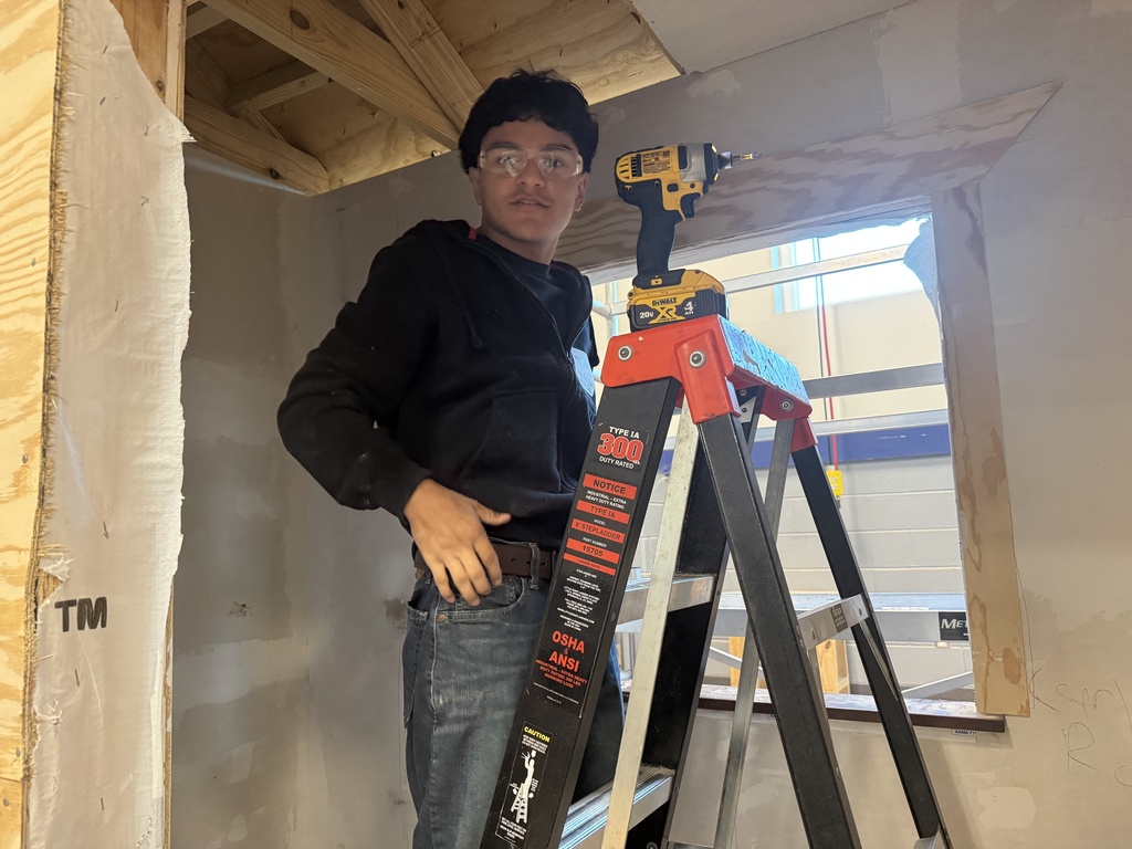 Construction II student taking apart building.
