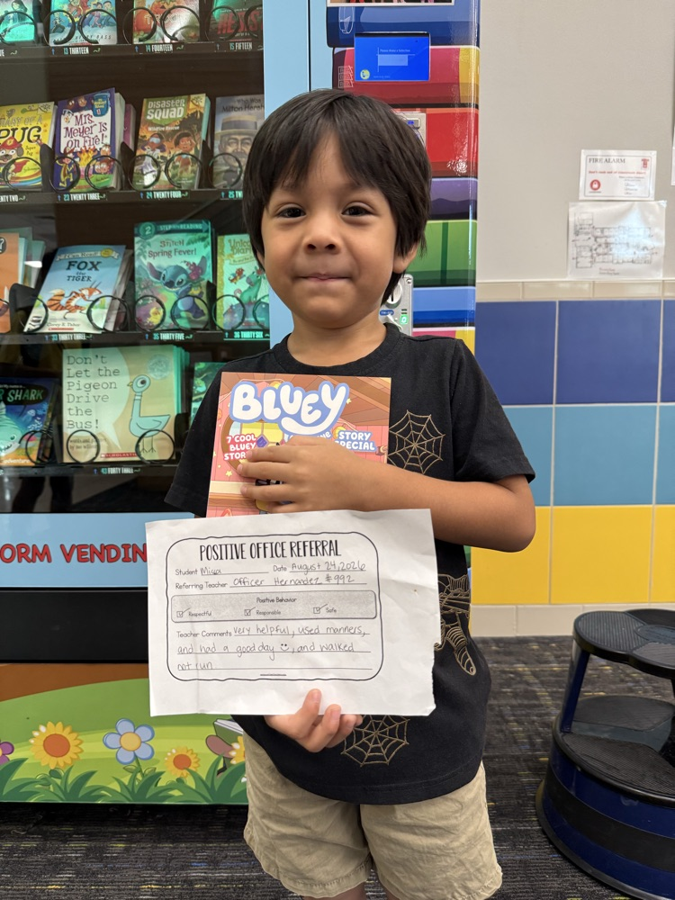 student with a book and positive office referral