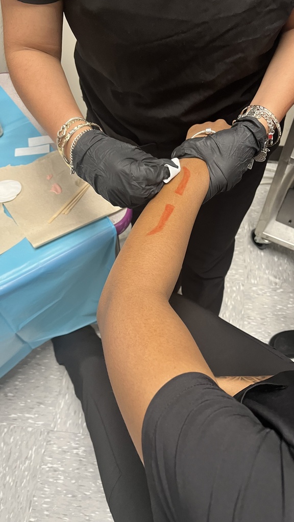 Cosmetology 2 students learning hair removal techniques.