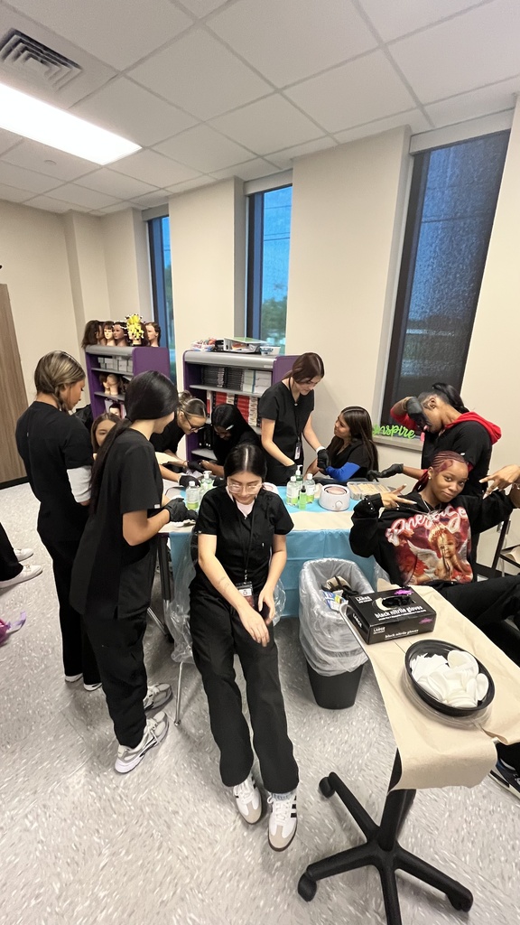 Cosmetology 2 students learning hair removal techniques.