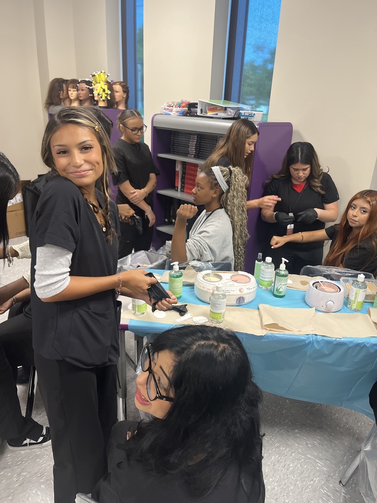 Cosmetology 2 students learning hair removal techniques.