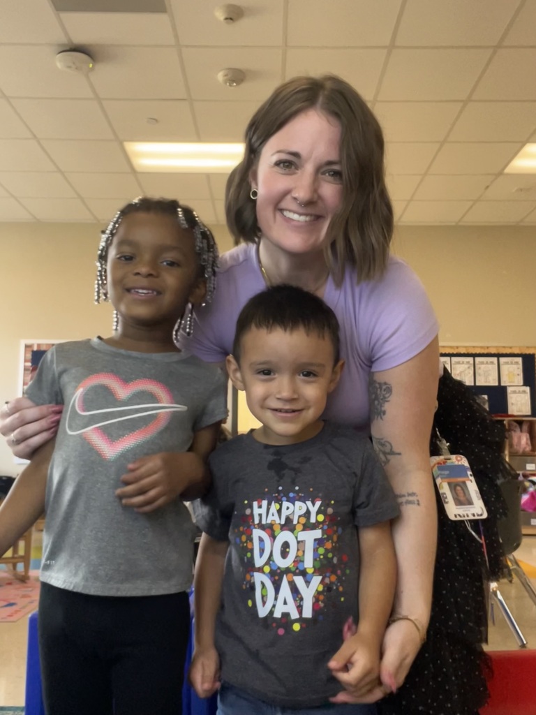 a teacher with two students dressed for dot day