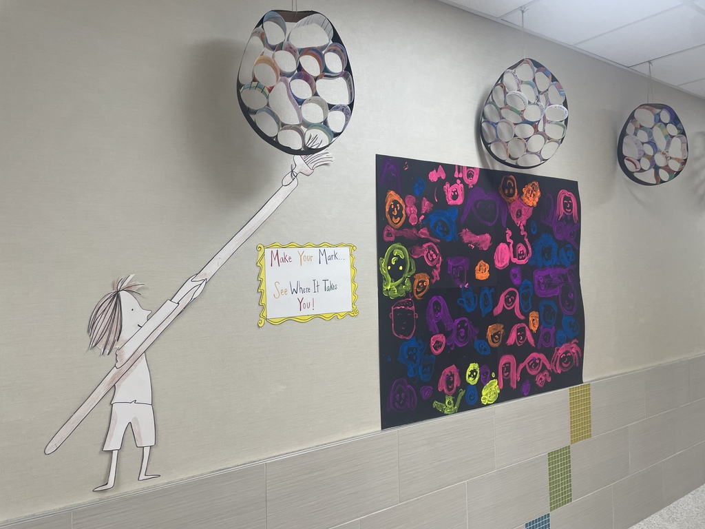 Art work hanging in the halls that students made for dot day.