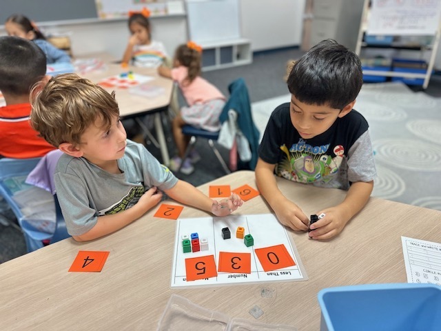 kids with numbers on mat