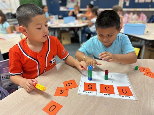 kids with numbers on mat