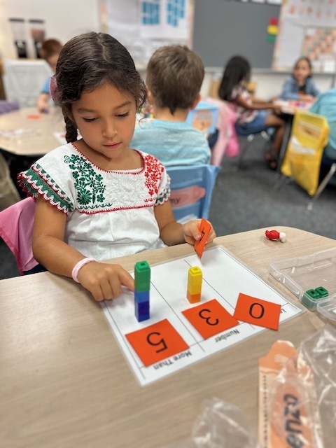 kids with numbers on mat
