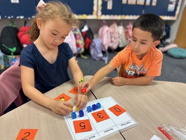 kids with numbers on mat