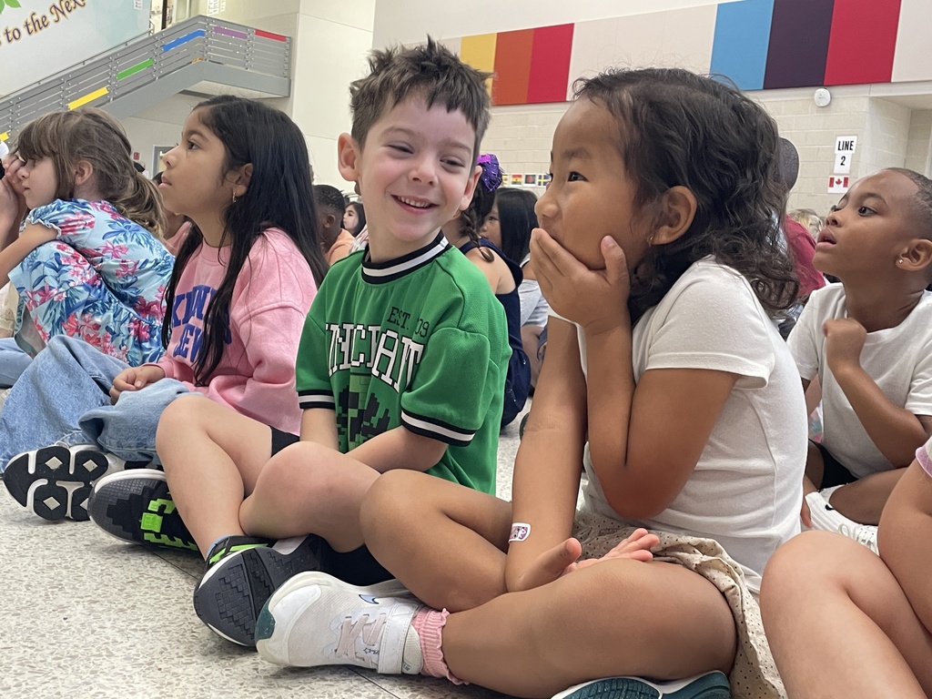 students watching and giggling as the students perform madagascar