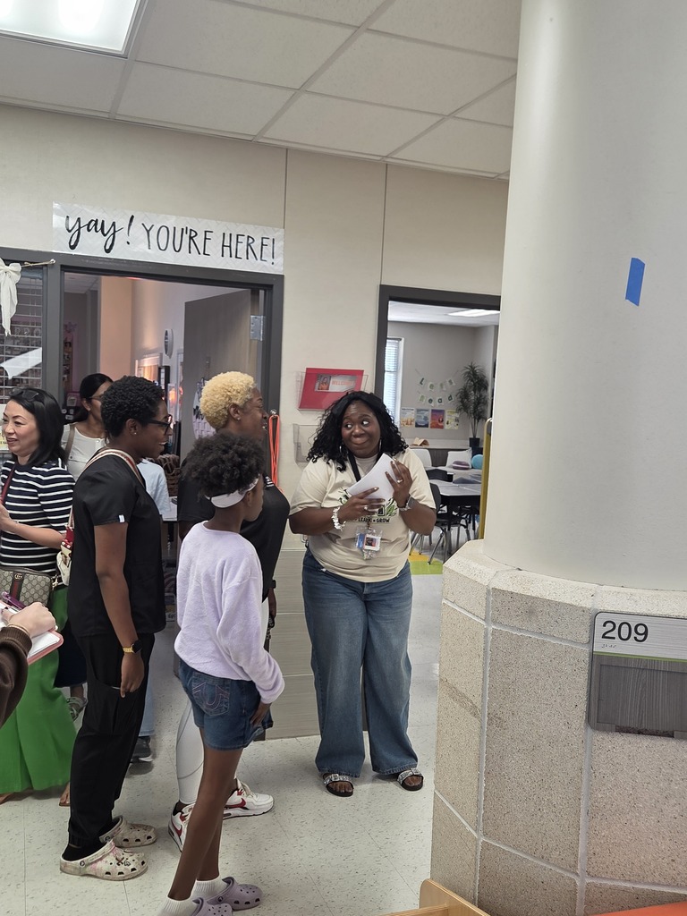 Students and parents in classrooms for Open House.  