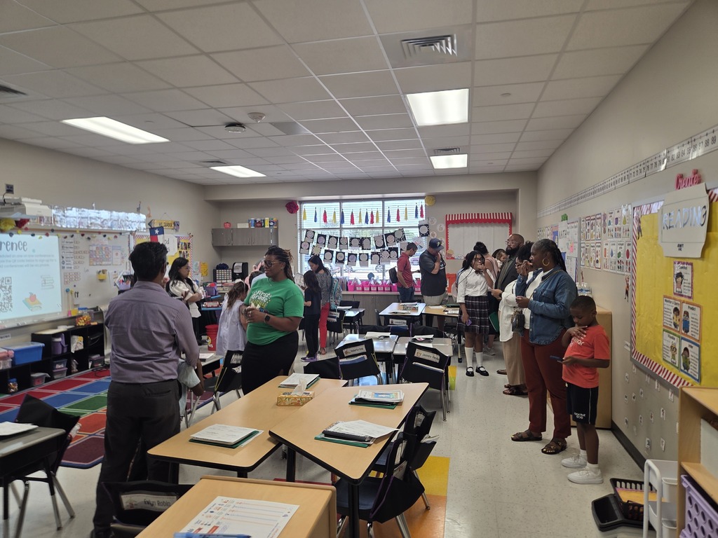 Students and parents in classrooms for Open House.  