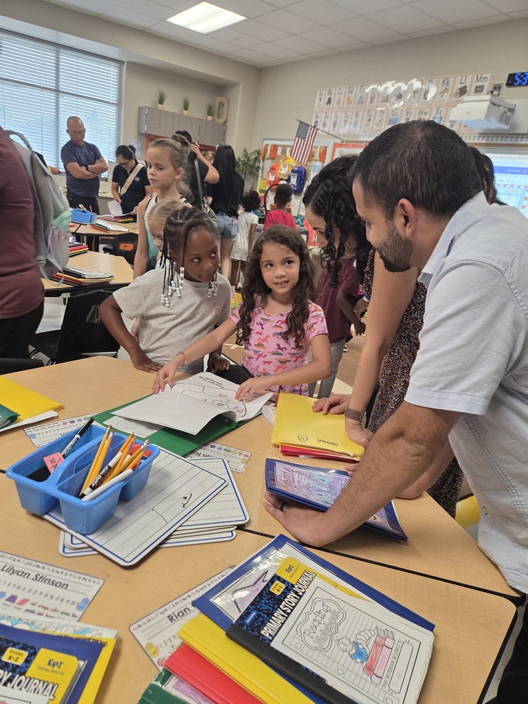 Students and parents in classrooms for Open House.  