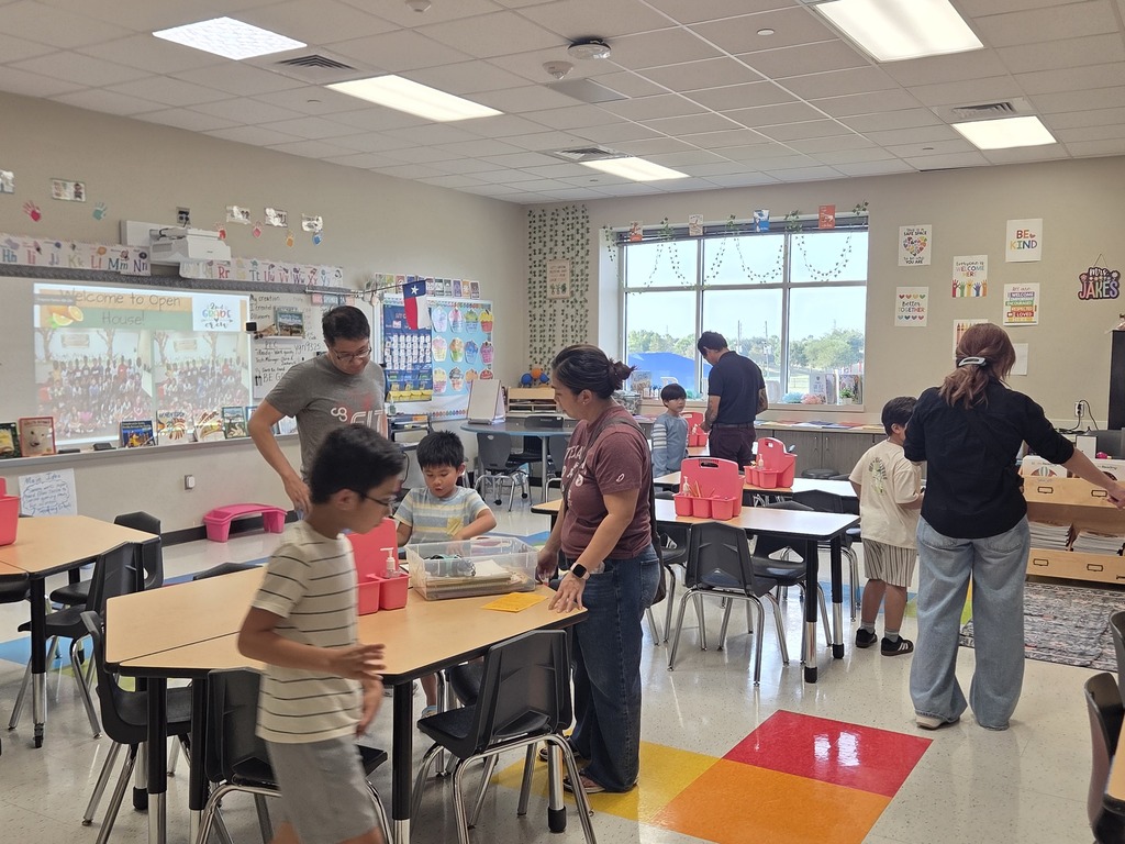 Students and parents in classrooms for Open House.  