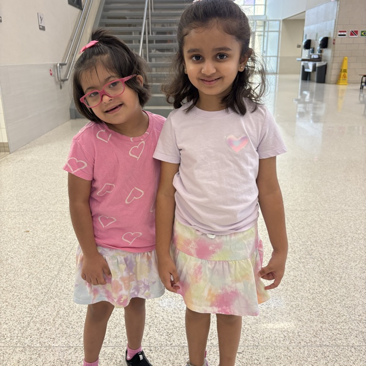 kindergarten students in matching outfits. tie-dye skirts and heart shirts. 