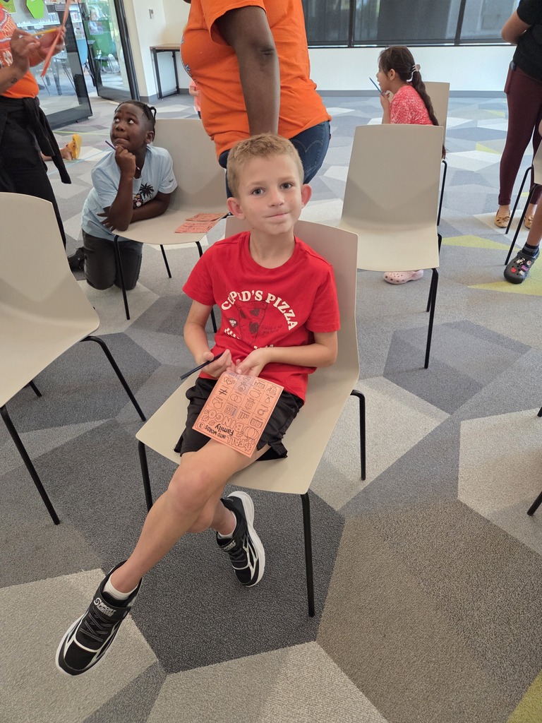 Student participating in bingo at the family academic night