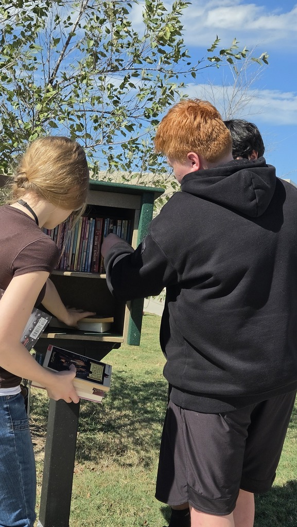 Student Library Helpers stocking the HAWKS Little Library