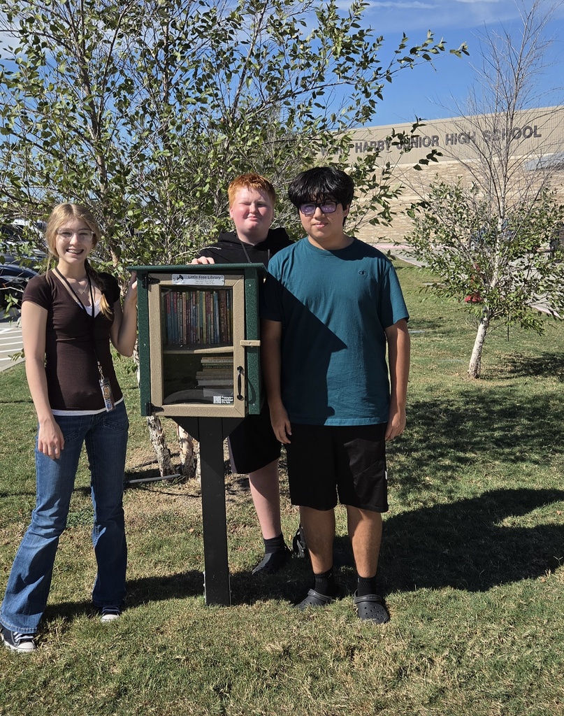 Students with the HAWKS little library