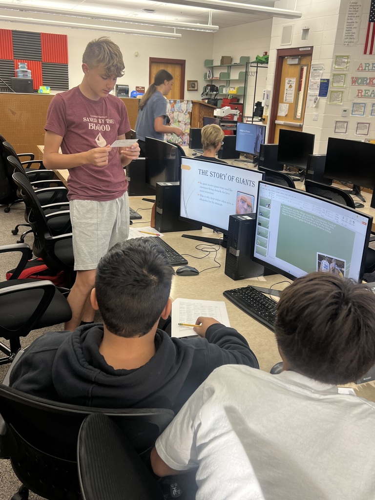 Student being prepared with notecards during their presentation 